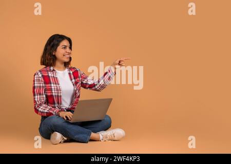 Smiling young middle eastern woman student with laptop Stock Photo