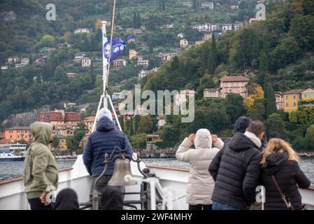 VARENNA, ITALY - OCTOBER 05, 2023 - Tourists waiting for the ferry to dock at the harbor of Varenna, lake Como Stock Photo