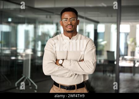 Confident young African American business man standing in office, portrait. Stock Photo