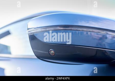 Luxury car detail right back mirror parking camera closeup. Road safety concept. 360 terrain surround system option of modern car. Side view rearview Stock Photo