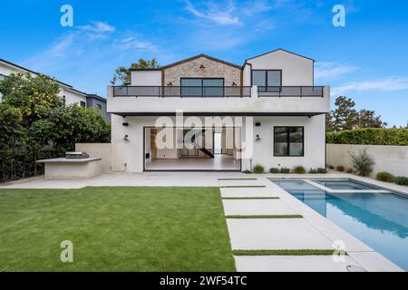 Contemporary home with pool and spacious yard under clear skies Stock Photo