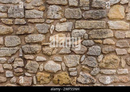 Old stone wall with natural stones. Stock Photo