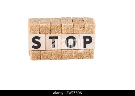 Brown sugar cubes and phrase stop isolated on white background Stock Photo