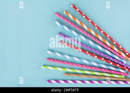 Different colordul paper straws on blue background Stock Photo