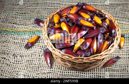 Corn cobs in a rustic basket on burlap Stock Photo