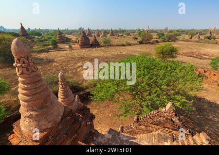 Scenic landscape of many ancient temples, small pagodas and ruins at the plain of Bagan in Myanmar (Burma) on a sunny day. Stock Photo