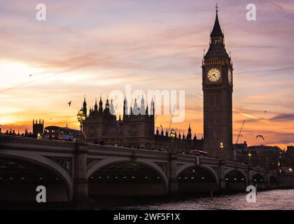 London, UK. 28th Jan, 2024. The Elizabeth Tower, commonly known as Big Ben, and Houses of Parliament on the Thames are silhouetted against the sky and setting sun. The London Eye is softly backlit as the sun is setting. A beautifully sunny day in London ends with clear skies and milder temperatures at sunset. Credit: Imageplotter/Alamy Live News Stock Photo