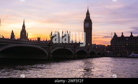 London, UK. 28th Jan, 2024. The Elizabeth Tower, commonly known as Big Ben, and Houses of Parliament on the Thames are silhouetted against the sky and setting sun. A beautifully sunny day in London ends with clear skies and milder temperatures at sunset. Credit: Imageplotter/Alamy Live News Stock Photo