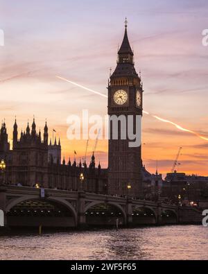 London, UK. 28th Jan, 2024. The Elizabeth Tower, commonly known as Big Ben, and Houses of Parliament on the Thames are silhouetted against the sky and setting sun. The London Eye is softly backlit as the sun is setting. A beautifully sunny day in London ends with clear skies and milder temperatures at sunset. Credit: Imageplotter/Alamy Live News Stock Photo