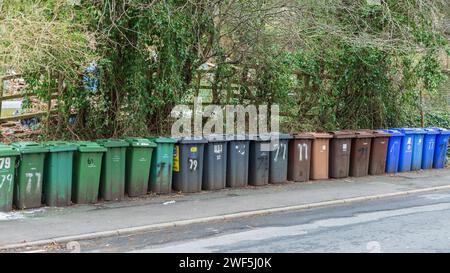 Wheelie Bins in a long line at the roadside waiting for collection Stock Photo