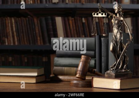 Law. Statue of Lady Justice, gavel and books on wooden table indoors Stock Photo