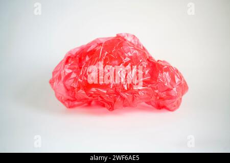 Crumpled red plastic bag isolated on white background Stock Photo