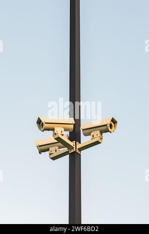 Security surveillance video cameras on pole safety protection monitoring crime three directions Stock Photo