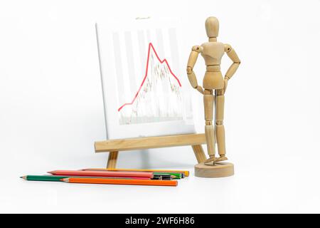 Mannequin drawing a graph charts on easel; isolated on white background; Business or finance concept Stock Photo