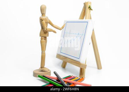 Mannequin drawing a graph charts on easel; isolated on white background; Business or finance concept Stock Photo