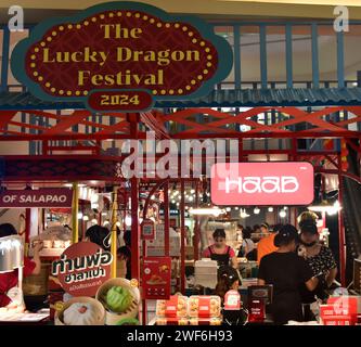 Lucky dragon festival signage at Silom Complex shopping mall, Bangkok, Thailand, South East Asia.  In Chinese culture 2024 is the year of the wood dragon. Chinese New Year 2024 will fall on Saturday, February 10th, 2024, starting a year of the Wood Dragon. Customers at food mart in mall. Stock Photo