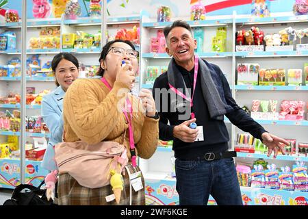 Cologne, Germany. 28th Jan, 2024. Chinese exhibitors talk with a visitor at ISM in Cologne, Germany, Jan. 28, 2024. The world's leading trade fair for sweets and snacks ISM runs from Jan. 28 to 31, 2024. Credit: Ulrich Hufnagel/Xinhua/Alamy Live News Stock Photo