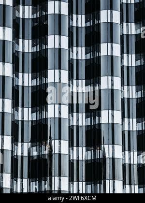 This photo captures a detailed close up of a towering modern skyscraper in the bustling downtown area of Gothenburg Stock Photo