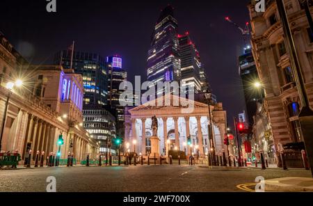 London. UK-01.27.2024. A night time view of the City of London showing the Royal Exchange, Bank of England and skyscrapers in the background. Stock Photo