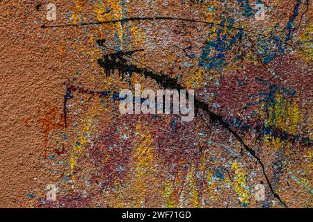 White plastered wall splattered with red paint. Paint splashes on the wall. Painted plaster wall. Abstract background. Painted plaster texture. Stock Photo
