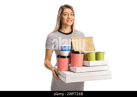 Happy young woman holding takeaway food boxes and coffee cups isolated on white background Stock Photo