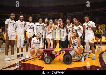 Arizona State Sun Devils pose with the victory bell after an NCAA basketball game between the Arizona State Sun Devils and Cal Golden Bears in Tempe, Stock Photo