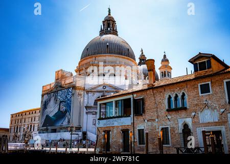 The domed silhouette of Santa Maria della Salute stands prominently along the Venetian skyline, a masterpiece of baroque architecture in Venice, Italy Stock Photo