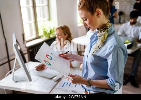 Creative managers crew, business people, designer working with new startup project in office. Stock Photo