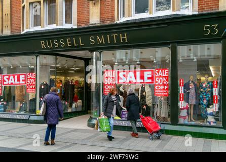 Sale poster signs in shop window of Russell Smith clothing store, Felixstowe, Suffolk, England, UK Stock Photo