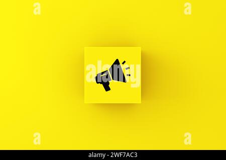 Announcement, communication, speech and voice concepts. Megaphone symbol on a yellow cube block. Stock Photo