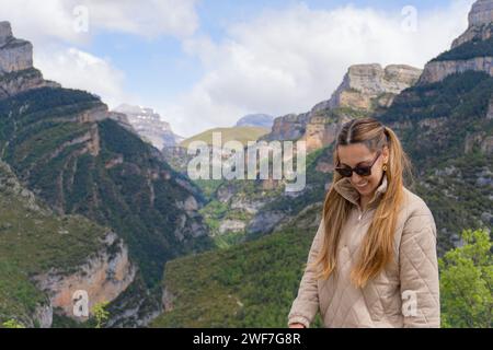 Woman with sunglasses and pigtails looks down in Añisclo Canyon Stock Photo