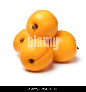 Heap of fresh ripe healthy nectarcot fruit close up isolated on white background Stock Photo