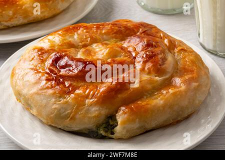 Plate with fresh homemade baked Turkish borek with spinach and cheese close up Stock Photo