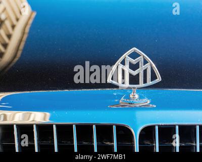 uzhgorod, ukraine - 31 oct 2021: close-up of a maybach limousine mascot on the hood with blurred cityscape architecture reflection Stock Photo