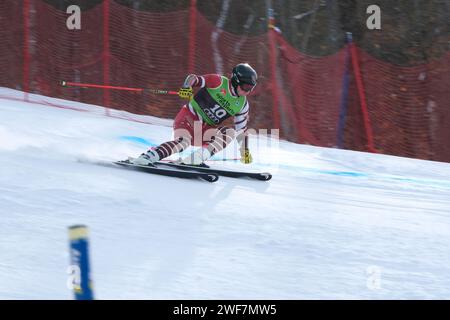 A male downhill ski racer competing in Quebec Super Series Giant Slalom race at Mont Ste Marie, Quebec Stock Photo