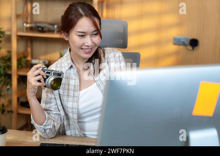 A young woman with a freelance profession as a photographer is processing images at home Stock Photo