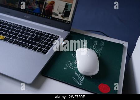 Mouse, mouse pad, and computer on a desk in the home office Stock Photo