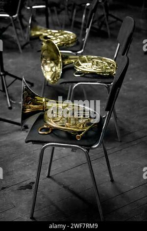 Image of a brass musical instrument horn lying on a chair Stock Photo