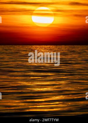 The golden sun rays reflection on the sea at sunset Stock Photo - Alamy