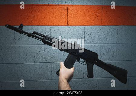 Russian assault rifle AK 74m with a collimator sight in a man's hand. High quality photo Stock Photo