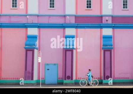 Copenhagen, Denmark. January 29th, 2023. A woman cycles past the Palads Cinema as Copenhagen Fashion Week begins in the city today. Credit: Katie Collins/EMPICS/Alamy Live News Stock Photo