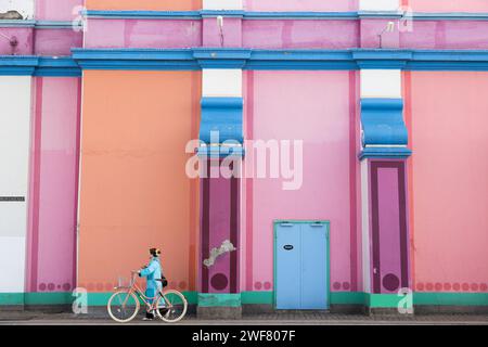 Copenhagen, Denmark. January 29th, 2023. A woman cycles past the Palads Cinema as Copenhagen Fashion Week begins in the city today. Credit: Katie Collins/EMPICS/Alamy Live News Stock Photo