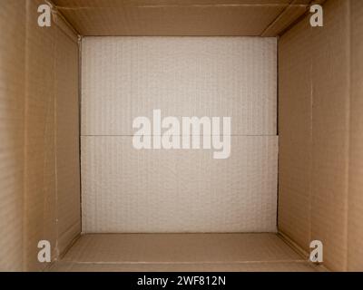 Opened cardboard box close up. Empty open rectangular cardboard box close up background and texture Stock Photo