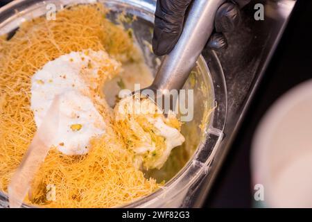 View of Kandaifi ice cream in the freezer being scooped. Soft focus Stock Photo