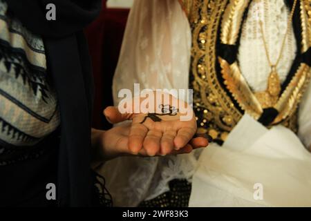 Flower henna tattoo on arabic bride's palm Stock Photo