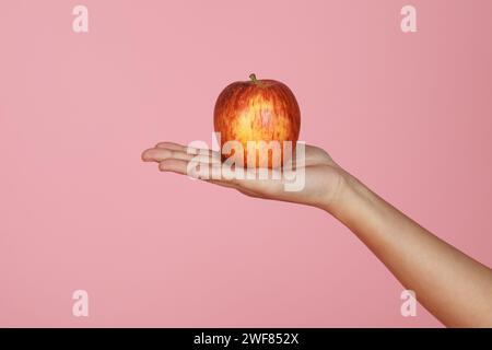 Closeup of hand holding fresh organic apple Stock Photo