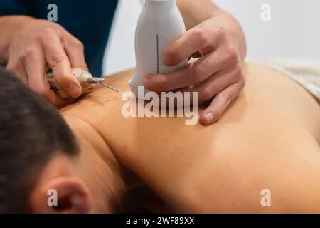 Close-up image showcasing a healthcare professional performing an ultrasound on a patient's back with a transducer and gel Stock Photo