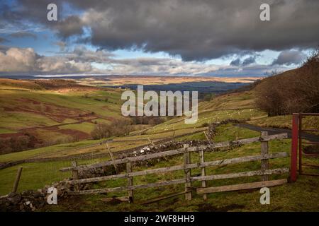 View looking north towards Wensleydale across West Burton from the single tracked road to Walden in North Yorkshire Stock Photo