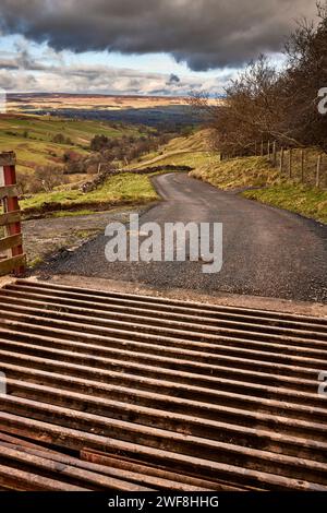 View looking north towards Wensleydale across West Burton from the cattle grid on the single tracked road to Walden in North Yorkshire Stock Photo