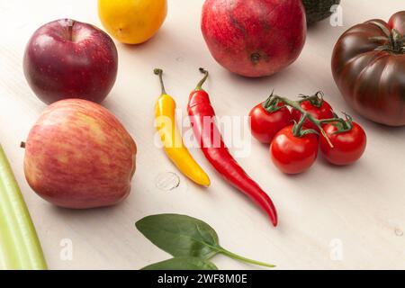 various fruits and vegetables on white wooden background Stock Photo